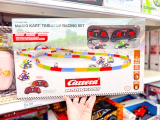 hand grabbing a mario kart racing set off a target shelf