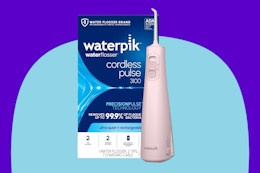 Waterpik Cordless Pulse Rechargeable Portable Water Flosser on a blue background.