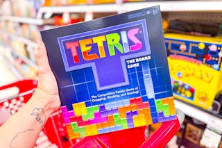 person holding a tetris board game over a cart