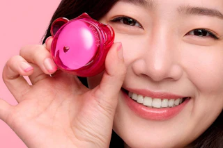 a woman holding a dr.jart+ jelly lip mask