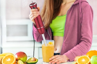 a girl using an Immersion Blender