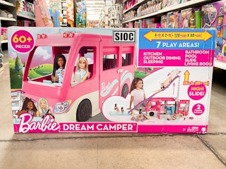 a box with a Barbie Camper on the floor in a store