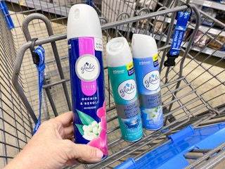hand holding glade spray in walmart cart