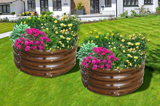 Lifestyle image of 2 round garden beds with flowers planted (brown galvanized)