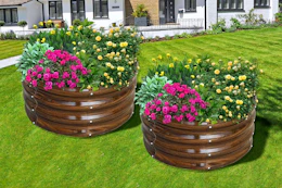 Lifestyle image of 2 round garden beds with flowers planted (brown galvanized)