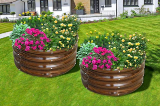 Lifestyle image of 2 round garden beds with flowers planted (brown galvanized)