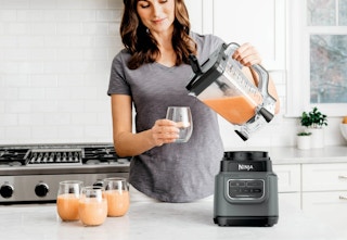 woman pouring smoothie out of a Ninja classic blender