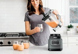 woman pouring smoothie out of a Ninja classic blender