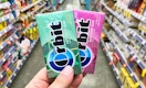 hand holding two packs of Orbit gum