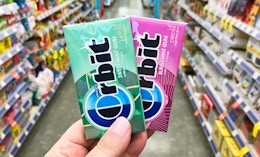 hand holding two packs of Orbit gum