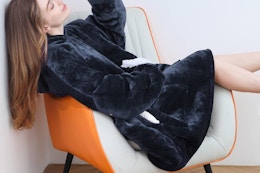 a woman wearing a wearable blanket hoodie