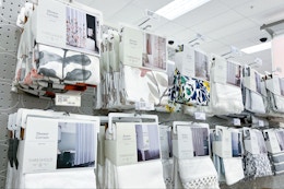 shower curtains sitting on a target shelf