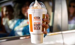 Person holding a root beer