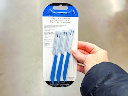 hand holding package of facial razors