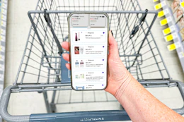 hand holding a smartphone displaying 1-clip coupon deals
