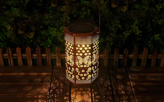 a candle on a butterfly-themed lantern
