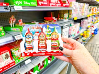 hand holding christmas kinder chocolate set in walmart aisle