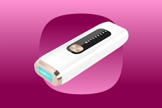 A handheld laser hair remover in cream and gold