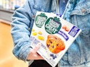 2 Veggies Made Great Muffin boxes being held by someone wearing a jean jacket in Walmart store (close up shot)