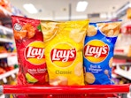 3 lay's chip bags sitting on top a target cart