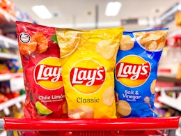 3 lay's chip bags sitting on top a target cart