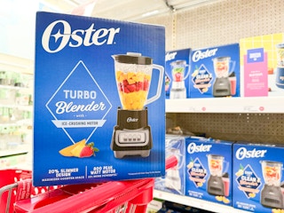oster blender sitting on top of a target cart in front of appliances