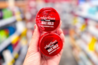 hand holding two kiss edge fixer hair fels in a store aisle