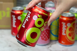 hand holding poppi cherry limeade soda