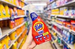 hand holding a bottle of tide rescue spray