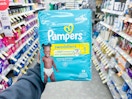 hand holding pampers diapers in walgreens