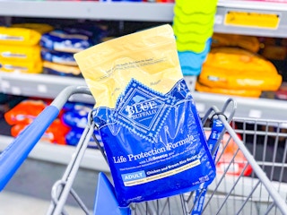 A bag of adult Blue Buffalo dog food in Walmart shopping cart