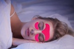 a woman sleeping with wrinkle patches