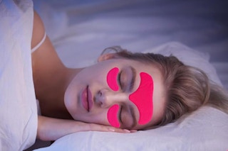 a woman sleeping with wrinkle patches