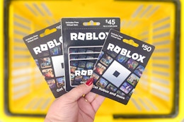hand holding roblox gift cards