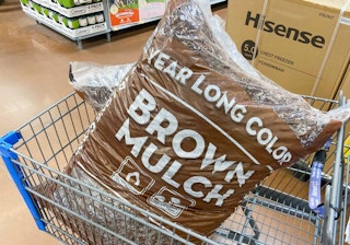 brown bag of mulch in a Walmart cart