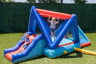 children playing in a bounce house