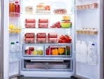 an open refrigerator with food and drinks in organizers