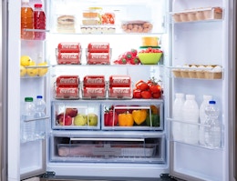 an open refrigerator with food and drinks in organizers