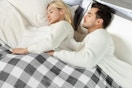 couple sleeping under heated blanket in bed
