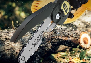 chainsaw cutting into tree