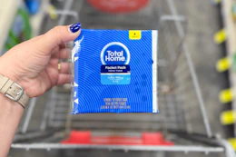 person holding a pack of tissues over a cart