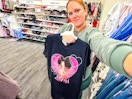 woman holding a kpop demon hunter graphic tee in target apparel