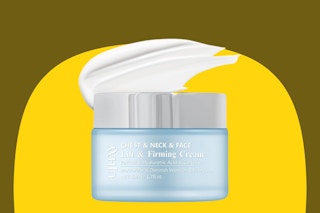 A blue jar of neck cream with a silver lid and a white dollop of that neck cream above it.