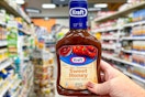 hand holding a bottle of kraft bbq sauce