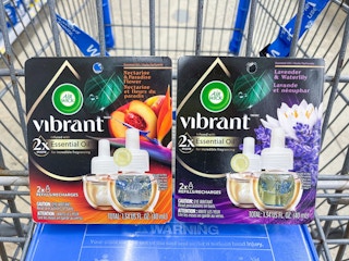 Two AirWick Vibrant refills sitting in a store cart.
