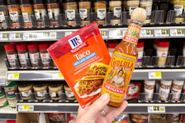 hand holding mccormick and cholula