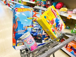 walgreens shopping cart with hot wheels, barbie, and play-doh toys