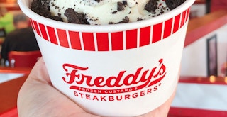 a person holding ice cream from freddys