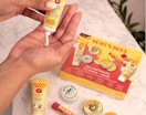 a person putting lotion in their hands over a Burt's Bees gift set