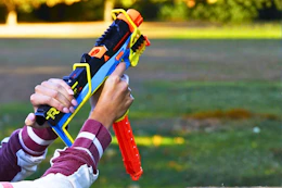 Lifestyle image of the Nerf Mirage Blaster (close up shot of someone holding it ourdoors)